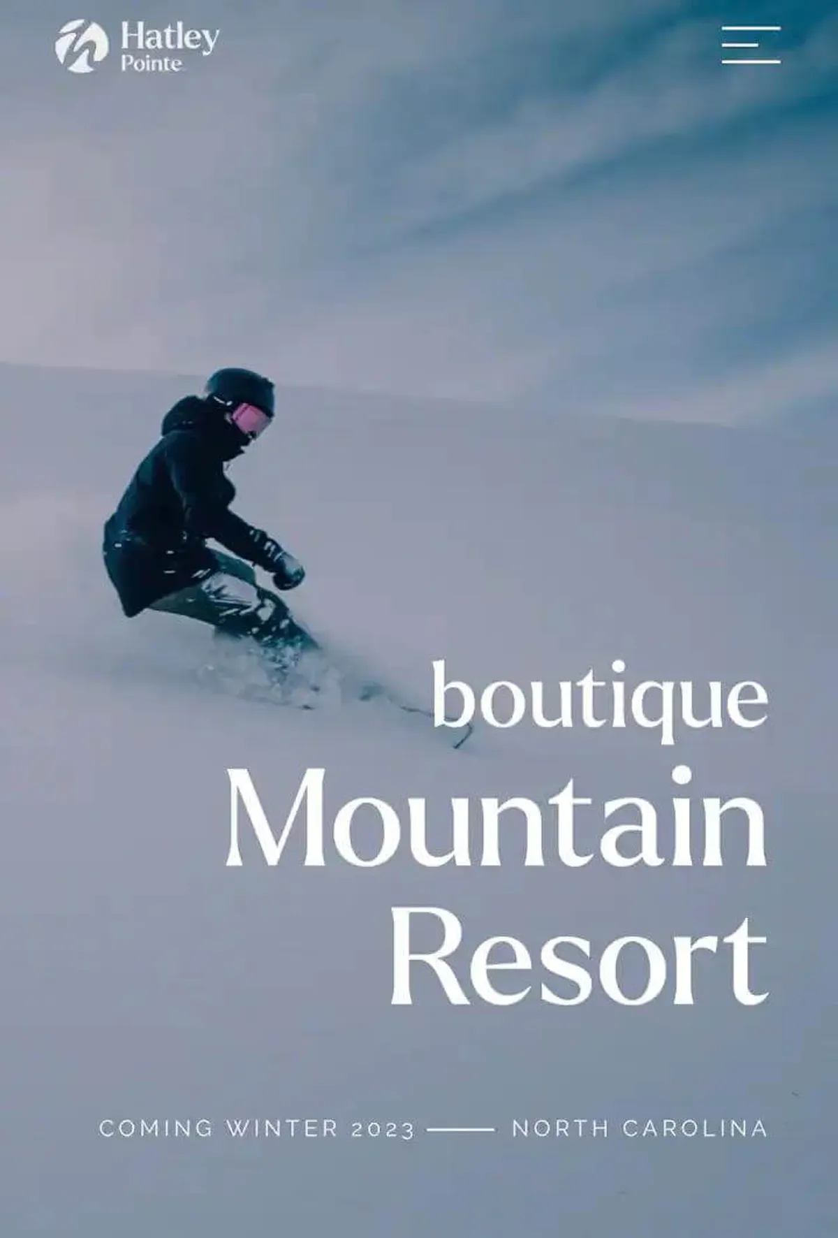 A dynamic action shot of a snowboarder carving down a snow-covered slope, surrounded by crisp mountain air and winter scenery. The energy of the scene captures the excitement and thrill of winter sports available just minutes from the cabin.